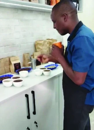 Coronet's cupper assessing lots in the cupping room